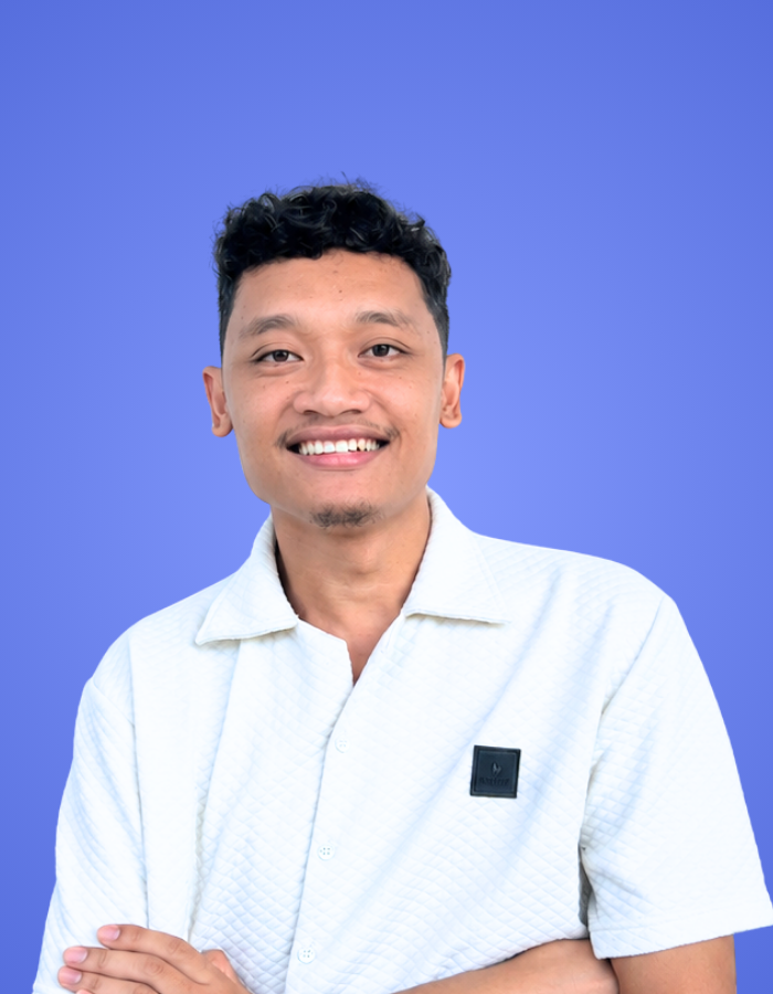 Male SitesGuru team member wearing a white shirt against a blue background.